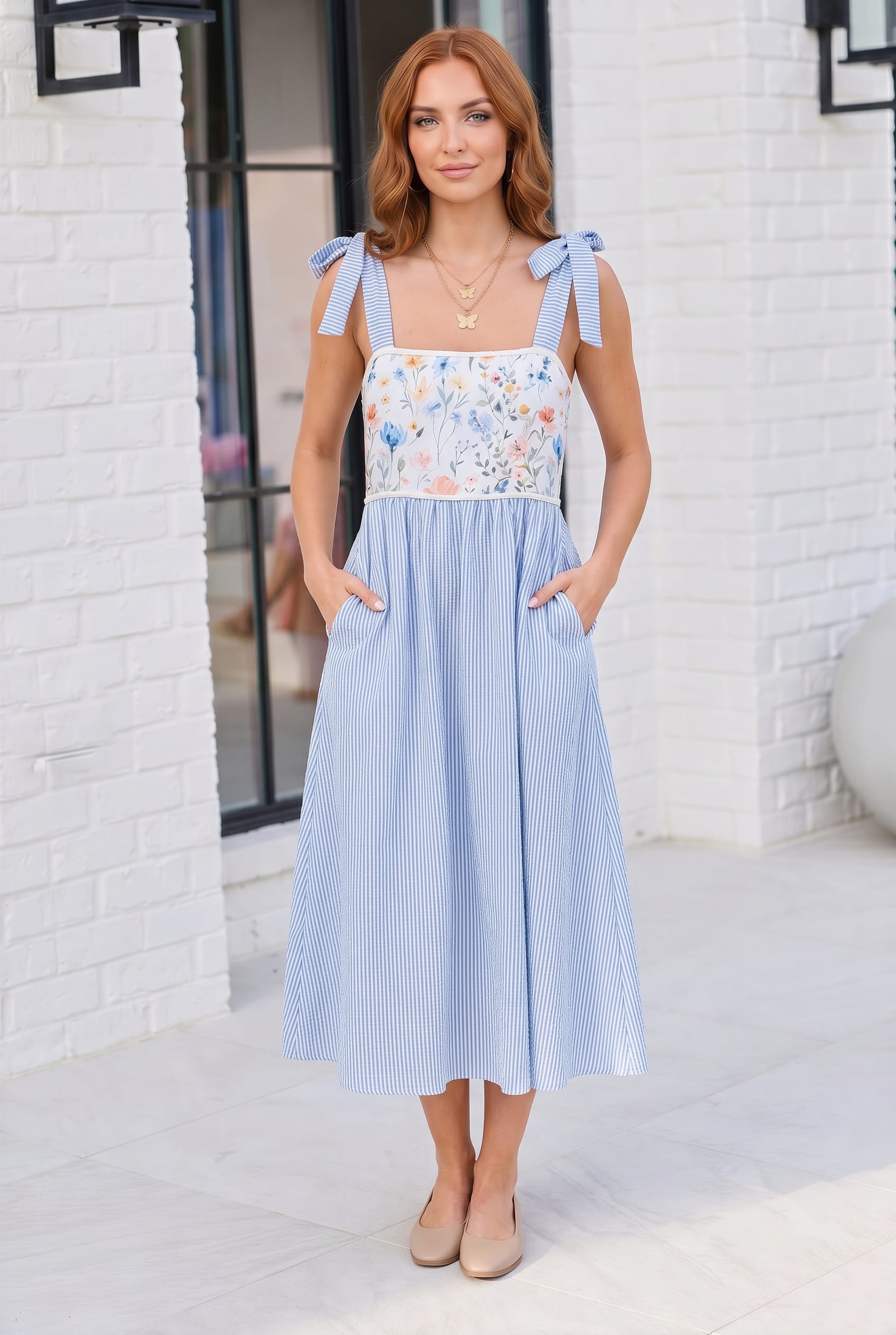 Woman wearing a light blue dress with floral top in an urban setting