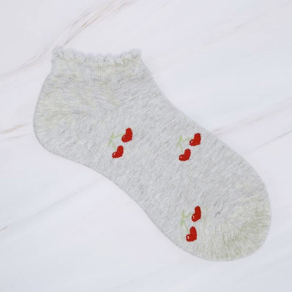 Gray ankle sock with red heart designs on a white background