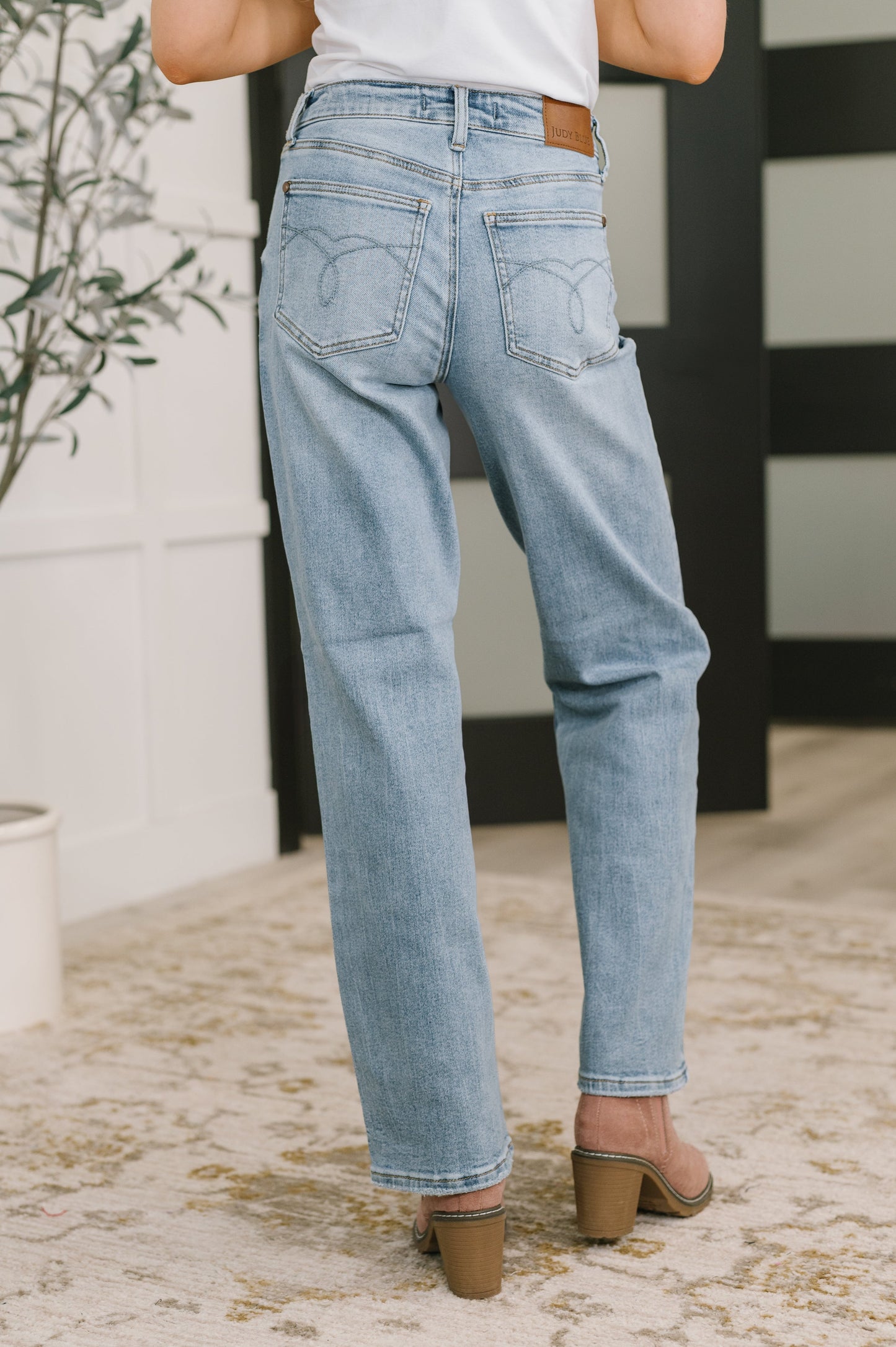 Light blue jeans worn by a person in an indoor setting