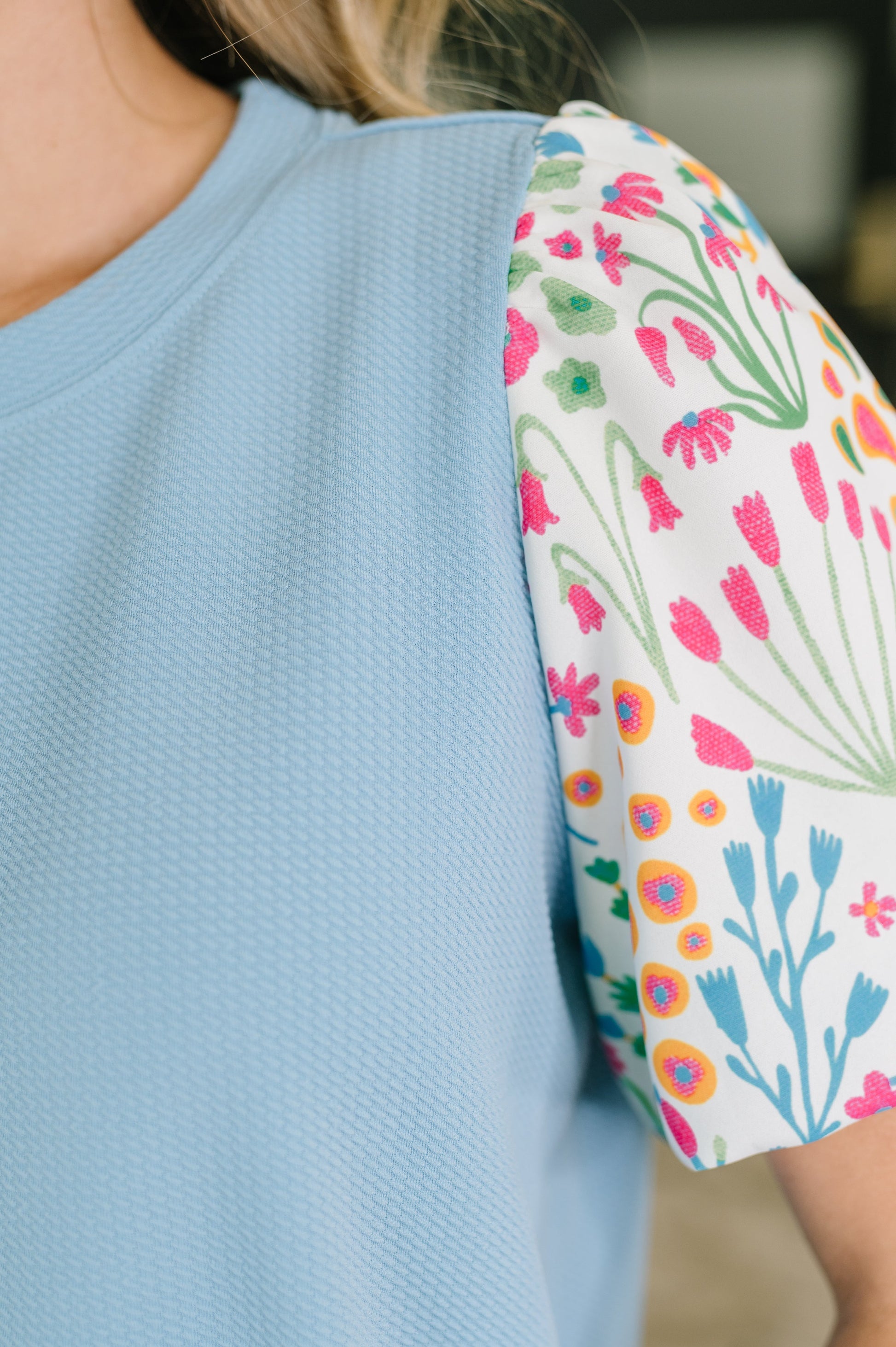 Light blue shirt with a floral sleeve