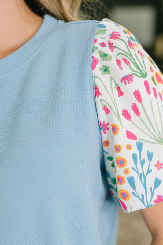 Light blue shirt with a floral sleeve