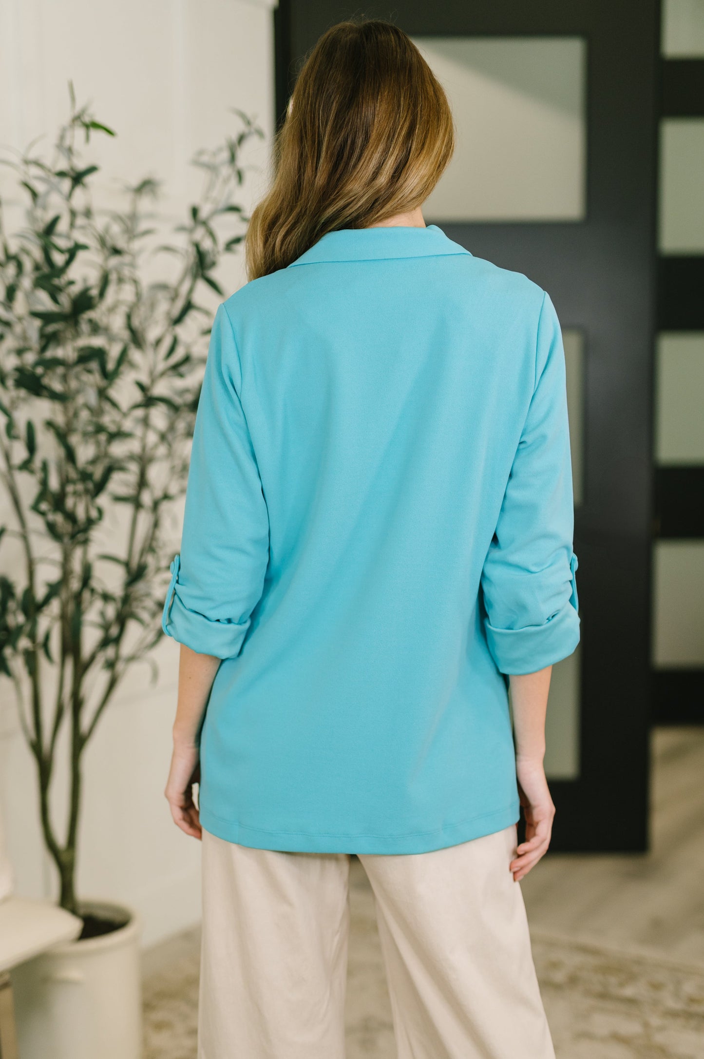 Person wearing a turquoise shirt in an indoor setting
