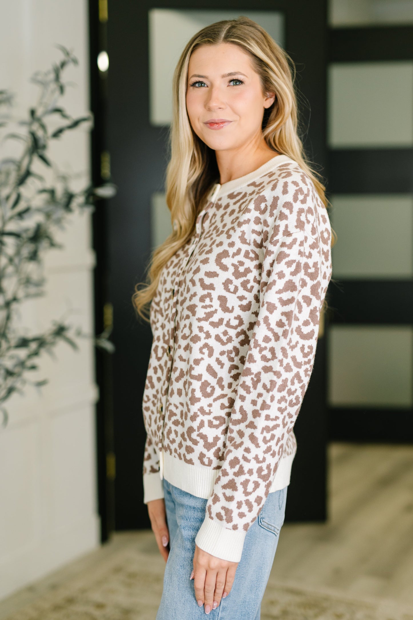 Woman wearing a leopard print sweater in an indoor setting