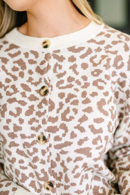 Close-up of a person wearing a leopard print shirt with buttons.