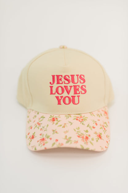 Cap with 'Jesus Loves You' text on a floral patterned brim against a white background