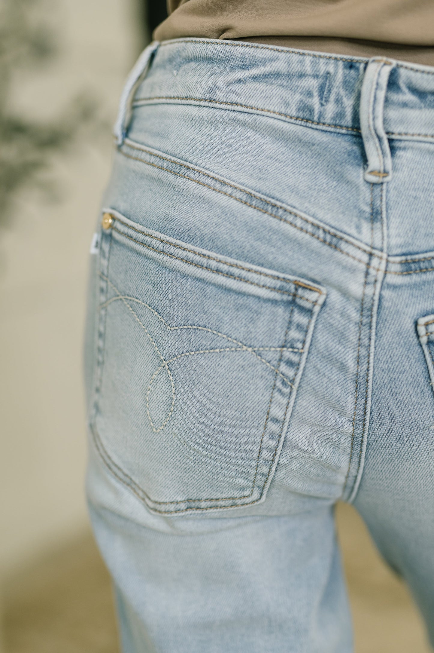 Close-up of light blue jeans with a blurred background
