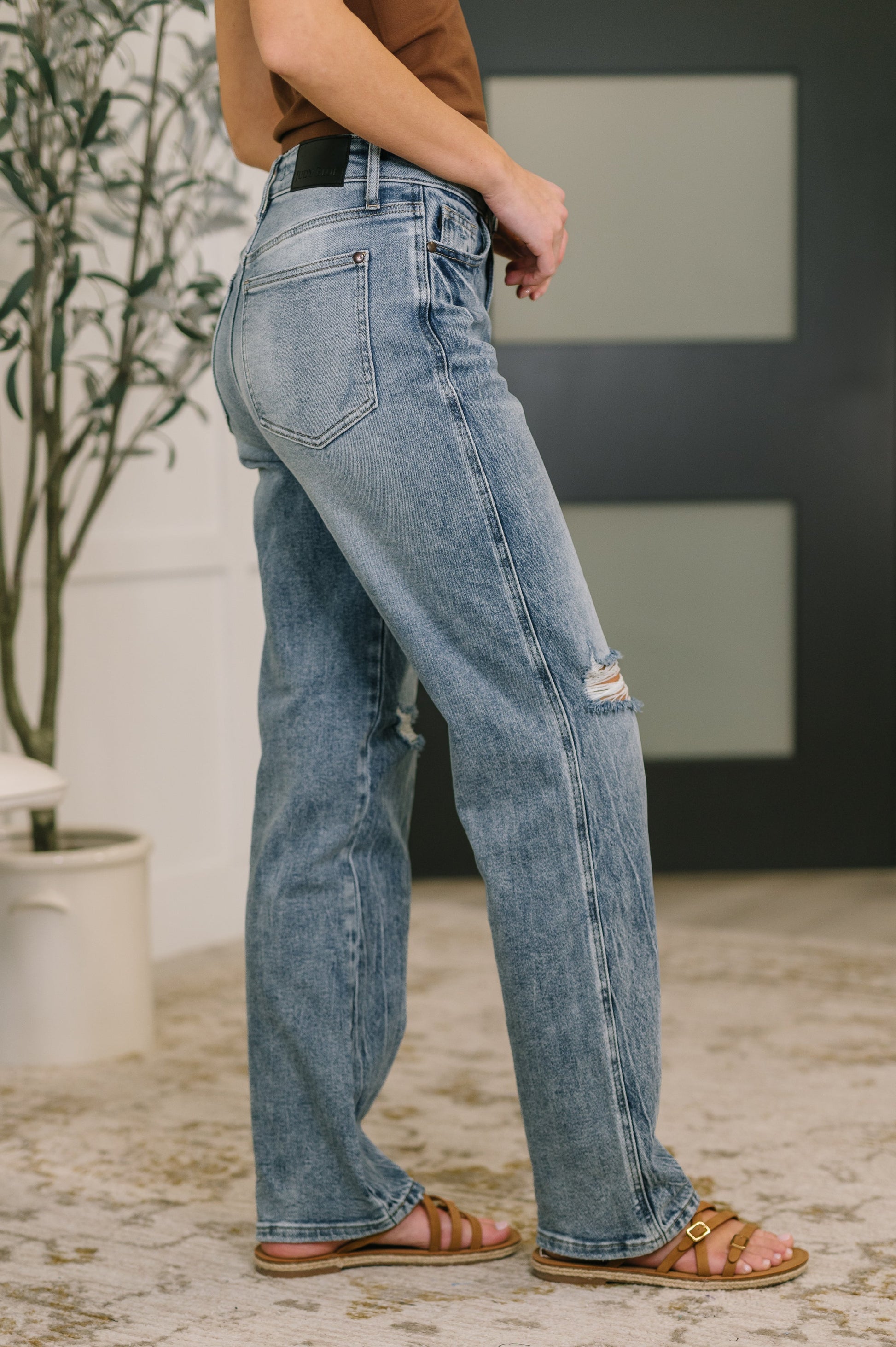 Person wearing blue jeans with a blurred background