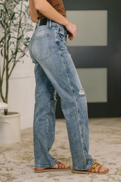 Person wearing blue jeans with a blurred background