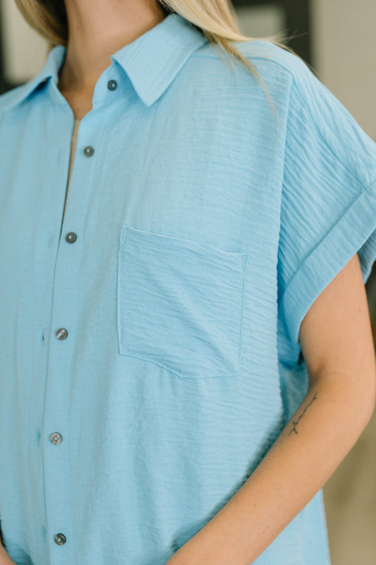 Light blue textured shirt worn by a person with a neutral background