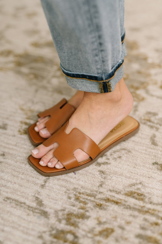 women wearing tan slip on sandals