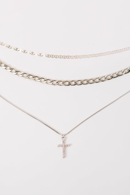 Two necklaces with a cross pendant on a white background