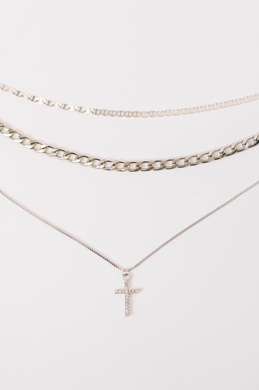 Two necklaces with a cross pendant on a white background