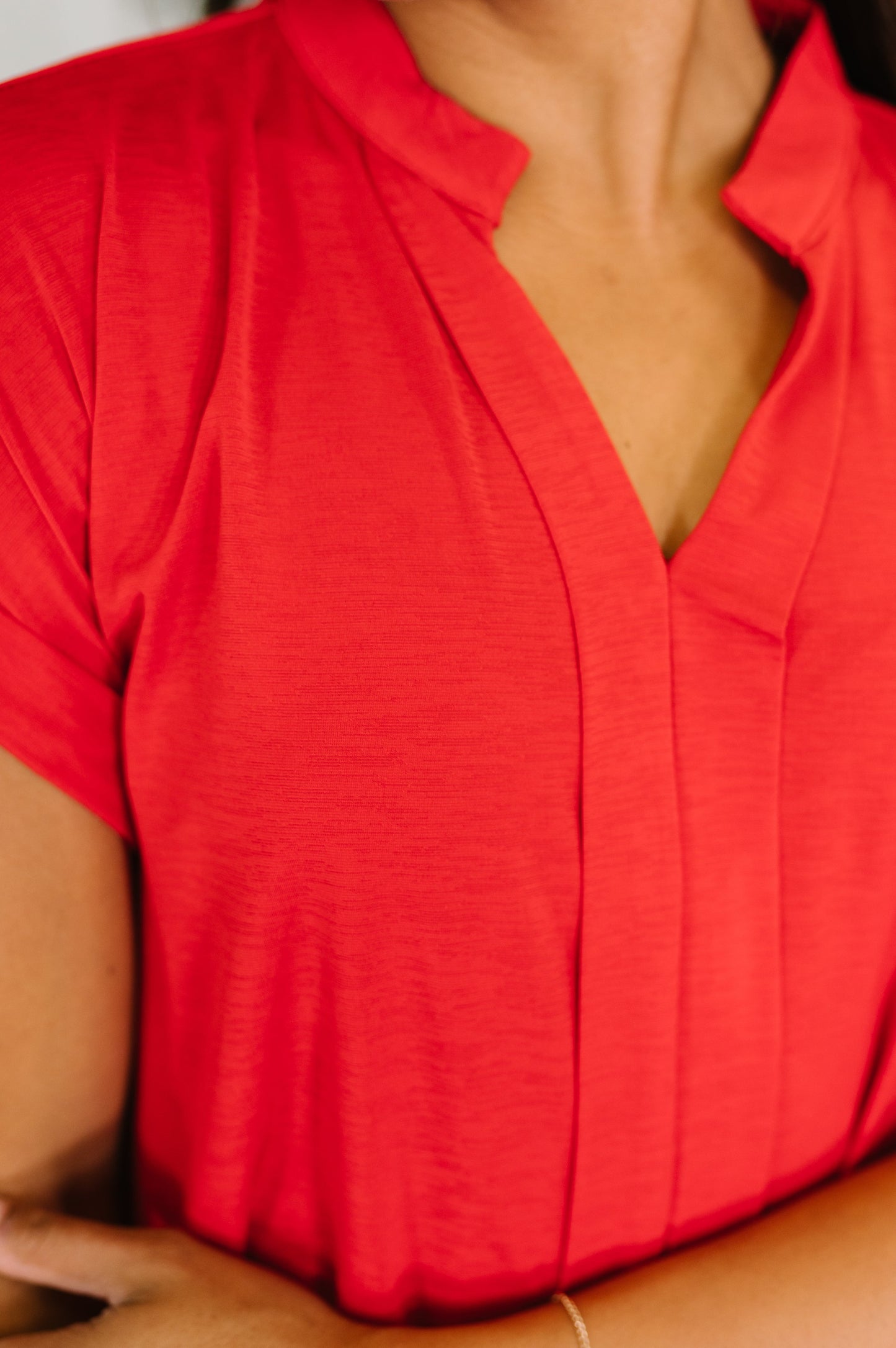 Close-up of a red blouse with a deep neckline