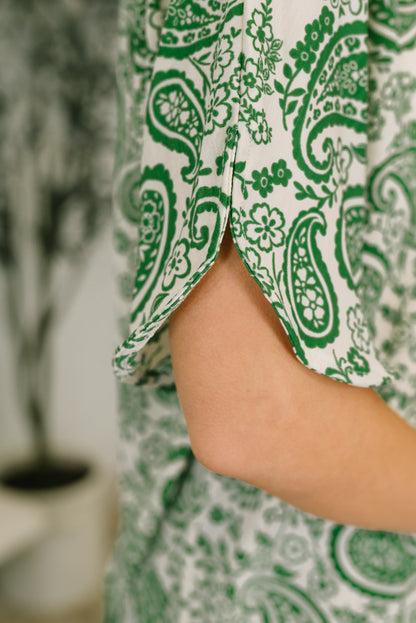 Green and white patterned fabric with a blurred background