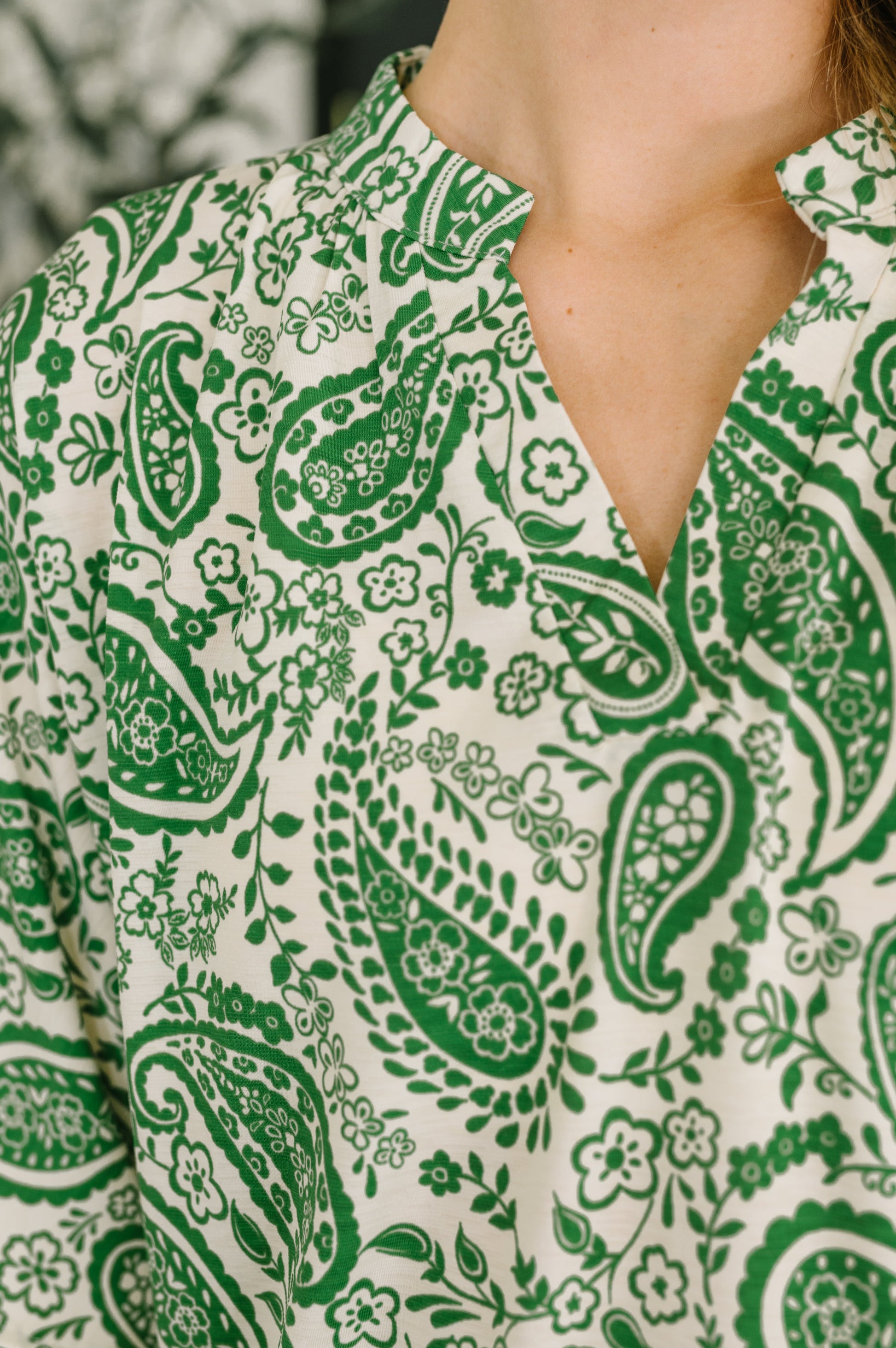 Green paisley pattern on a white shirt