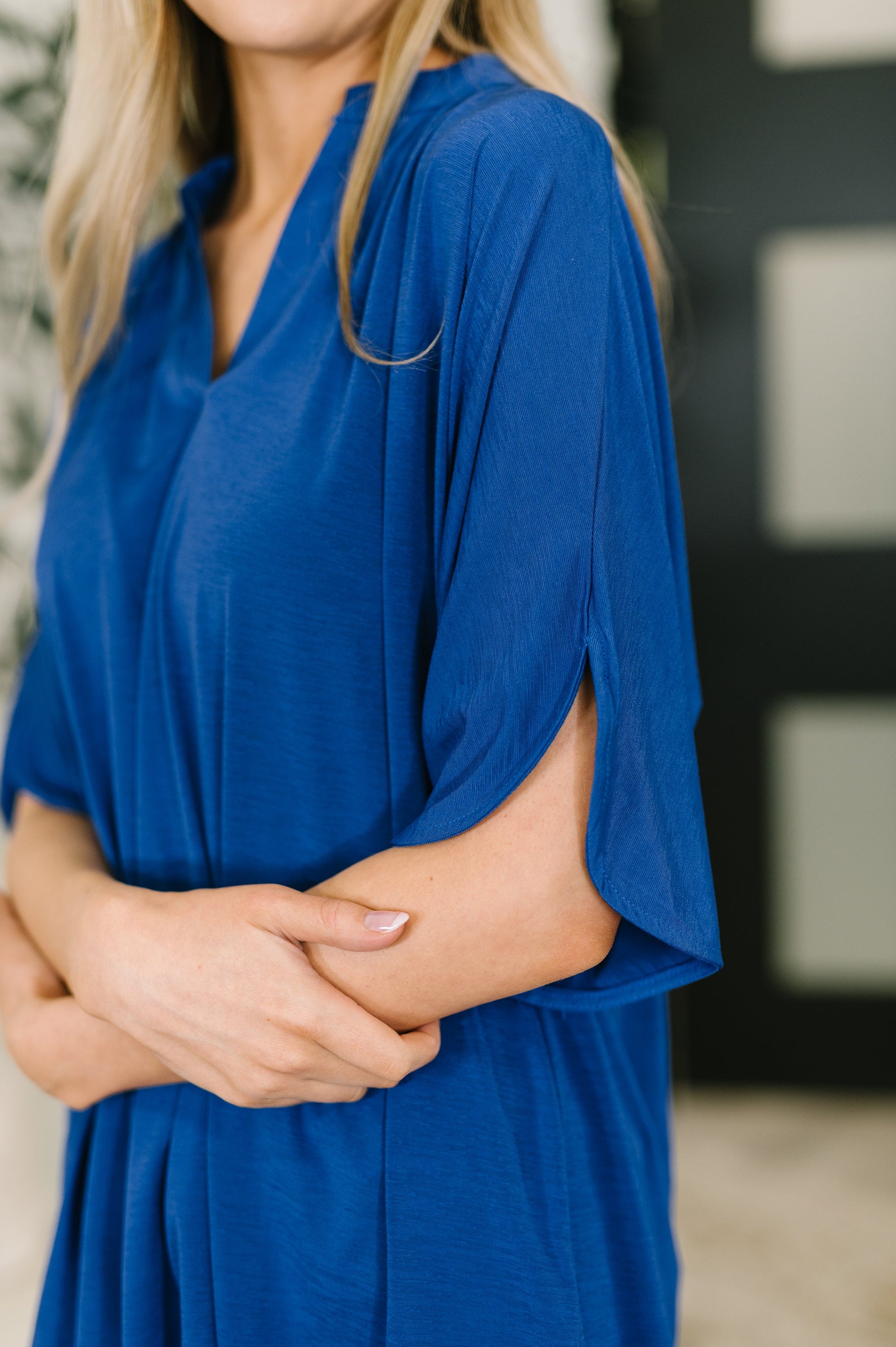 Woman wearing a blue dress with a blurred background