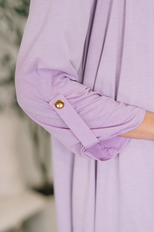 Close-up of a lavender garment with a button on a blurred background