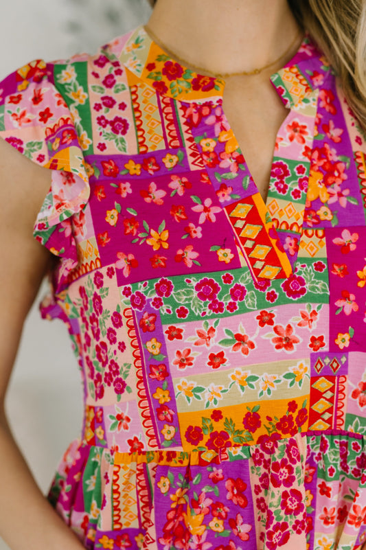 Colorful patchwork dress with floral patterns on a blurred background