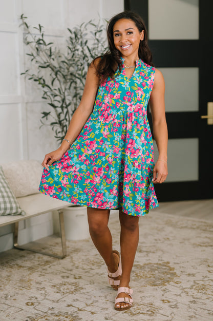 Woman wearing a colorful floral dress in an indoor setting