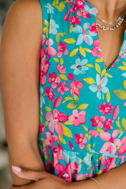 Close-up of a colorful floral dress with a turquoise background