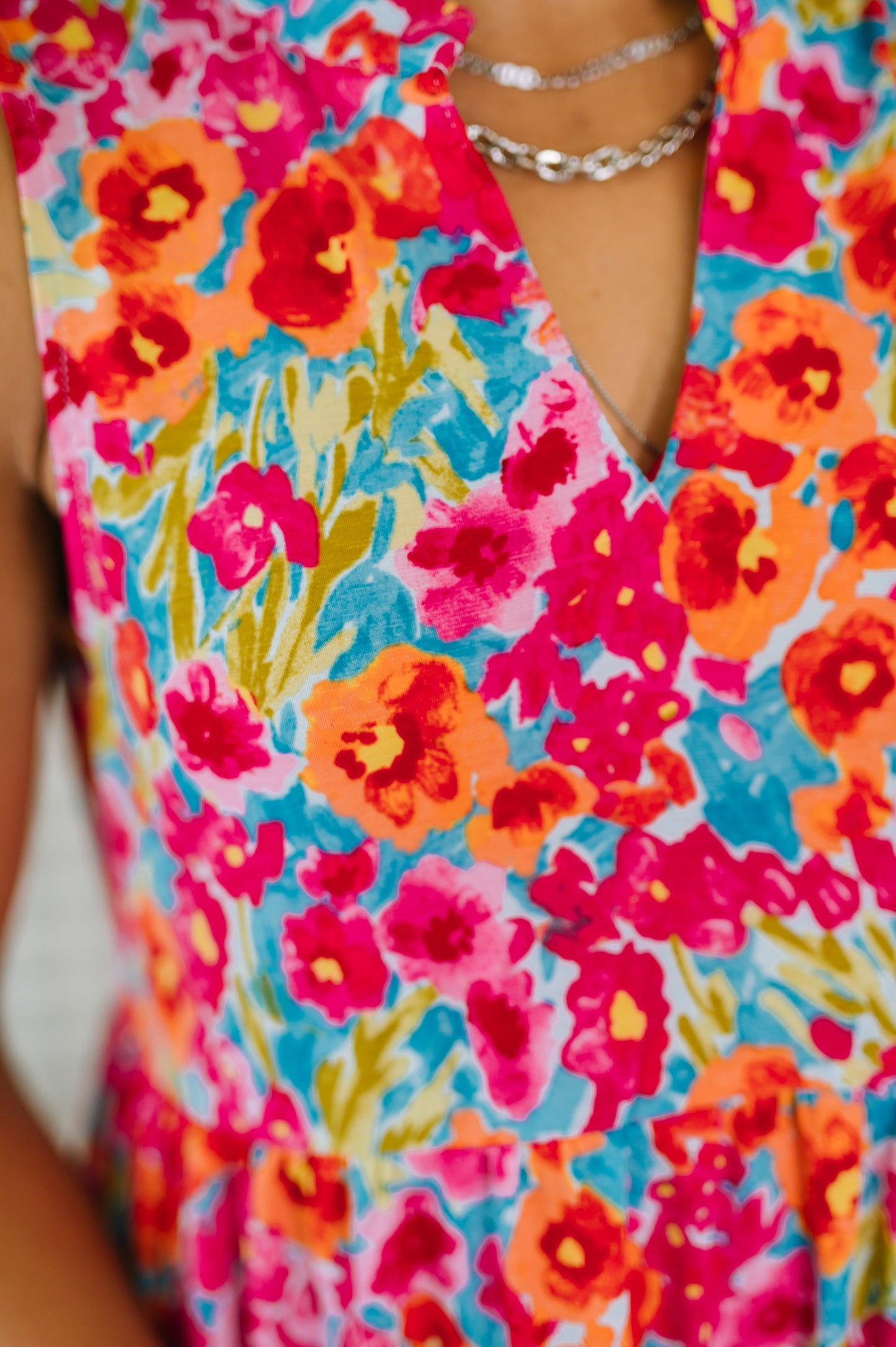 Colorful floral dress with vibrant pink, orange, and blue flowers.