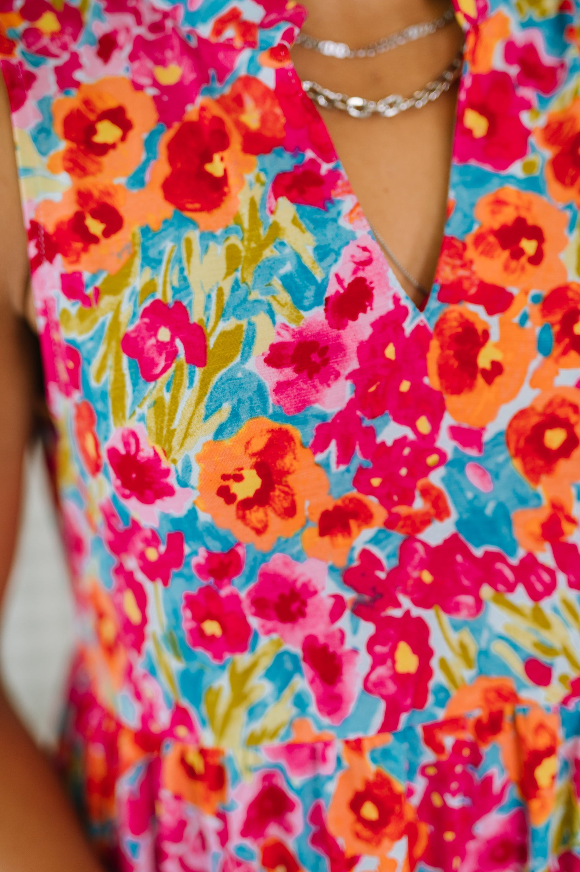 Colorful floral dress with vibrant pink, orange, and blue flowers.