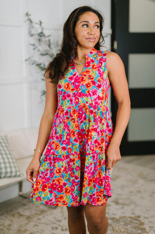 Woman wearing a colorful floral dress indoors