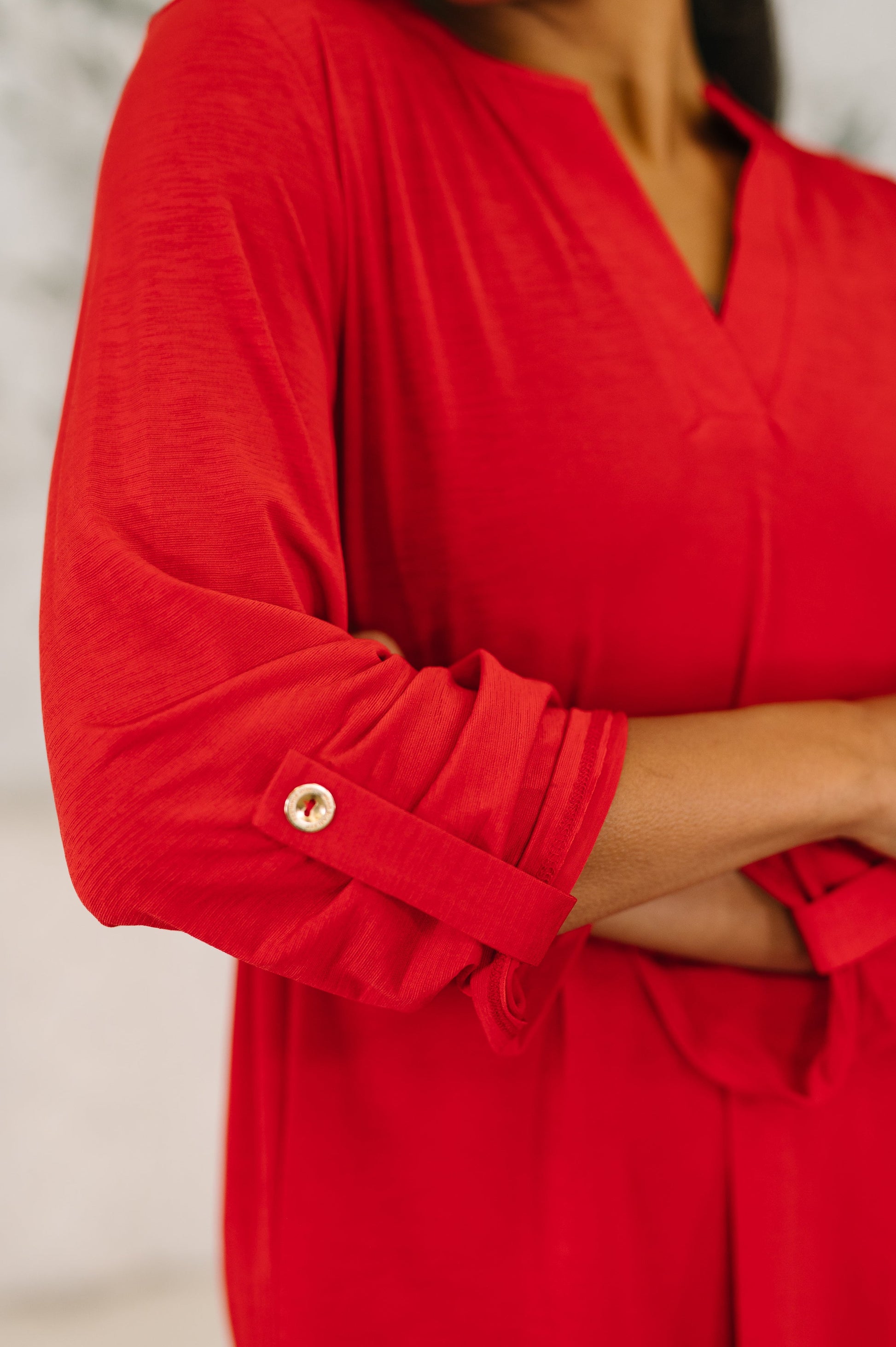 Red dress with rolled-up sleeves on a neutral background