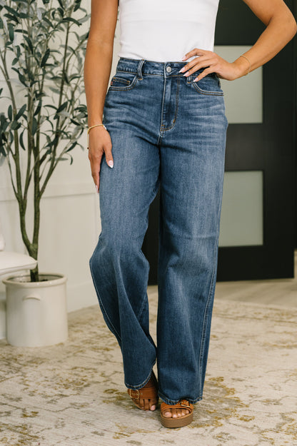 Person wearing blue jeans with a white background