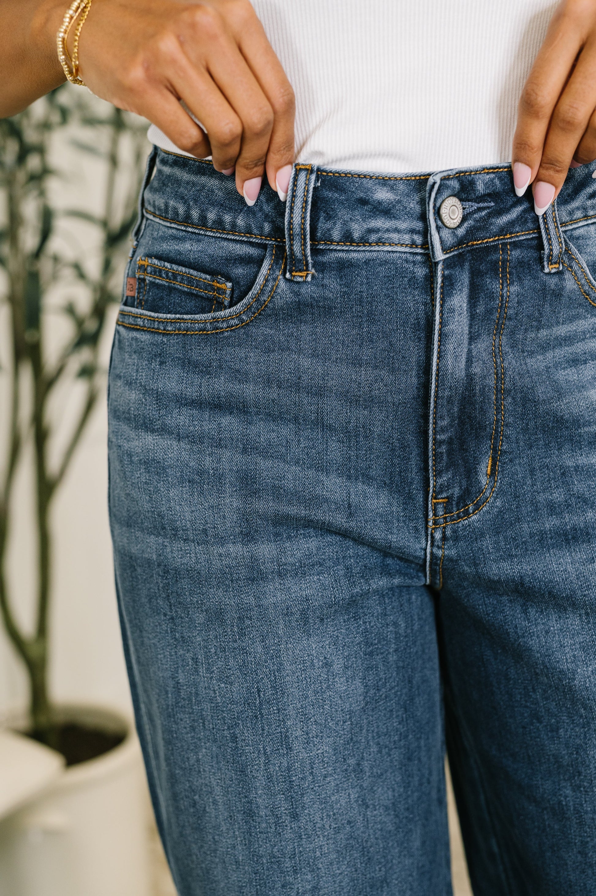 Person wearing blue jeans with a blurred background