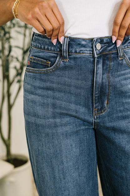 Person wearing blue jeans with a blurred background