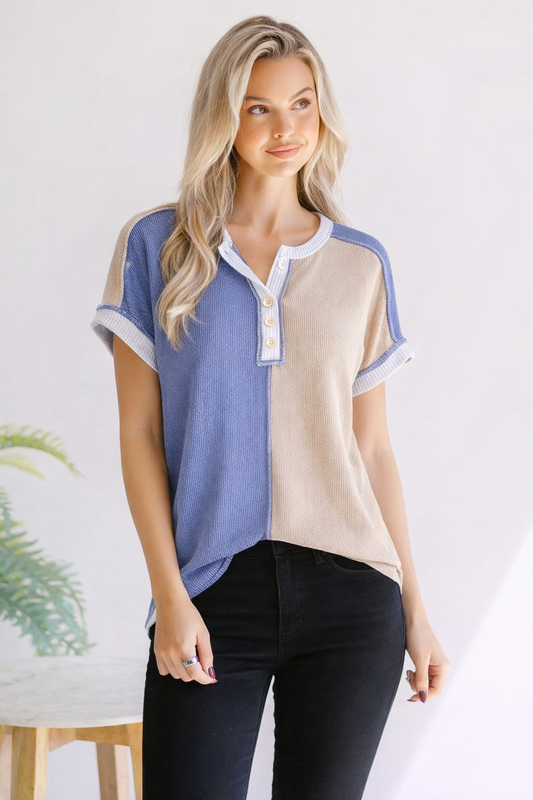 Woman wearing a two-tone shirt with blue and beige colors on a white background