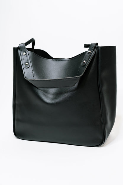 Black leather tote bag on a white background