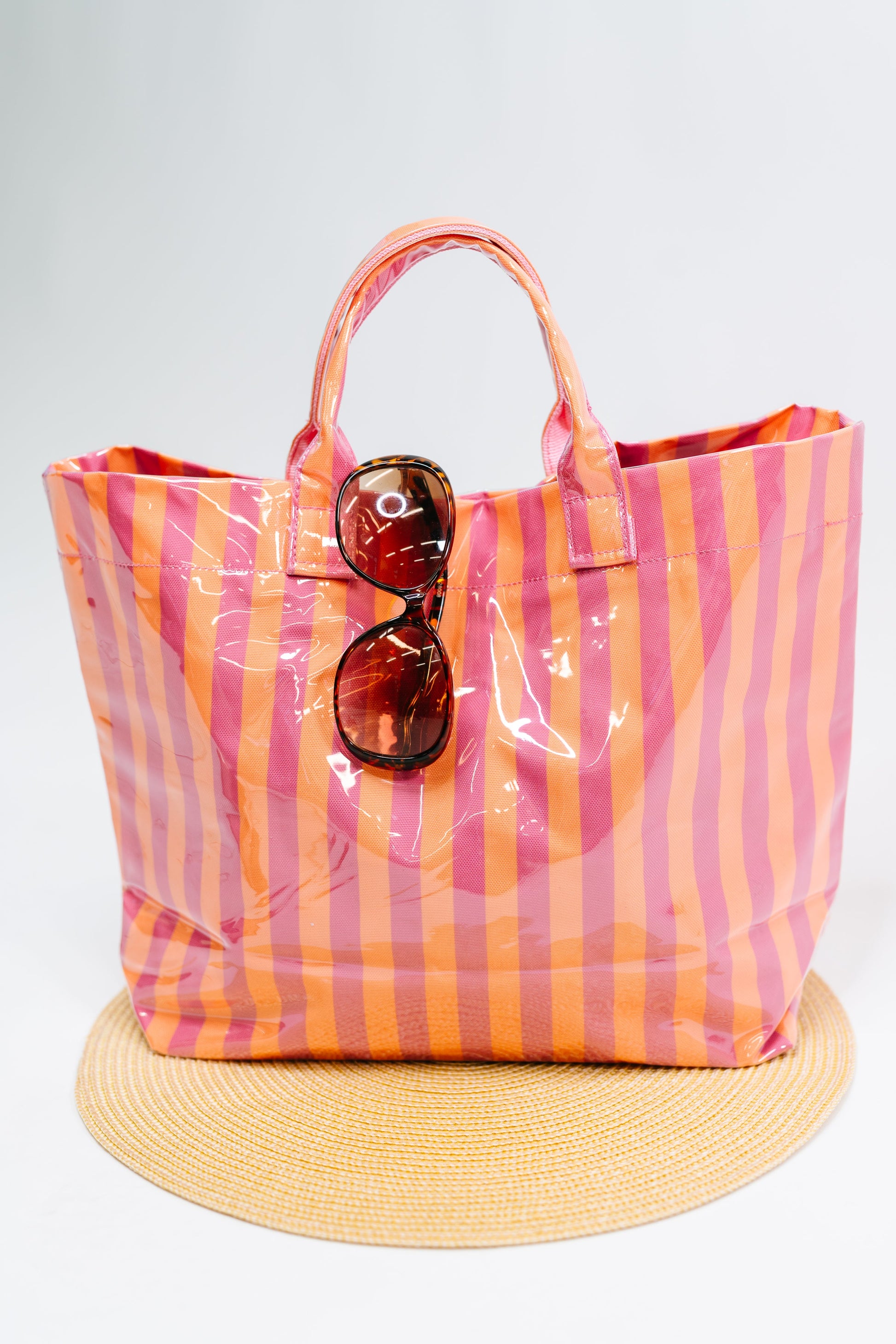 Striped tote bag with sunglasses on a white background