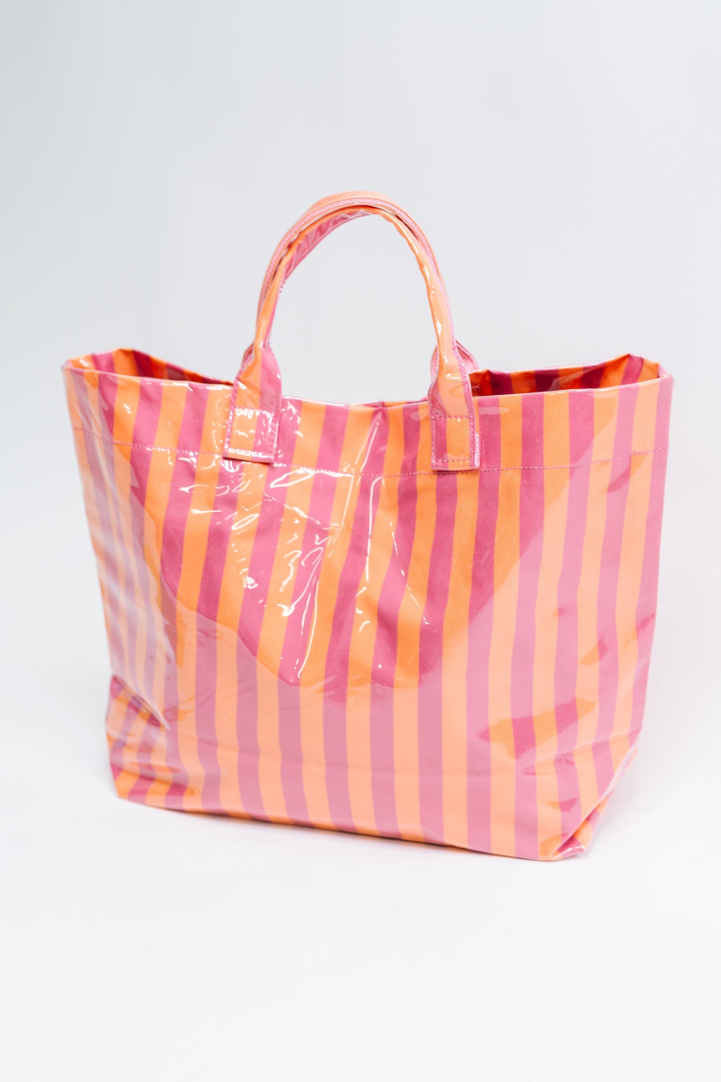 Striped tote bag with pink and orange pattern on a white background