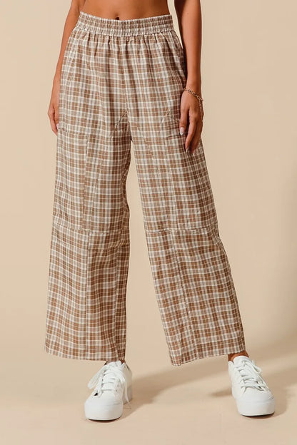 Plaid pants worn by a person on a beige background