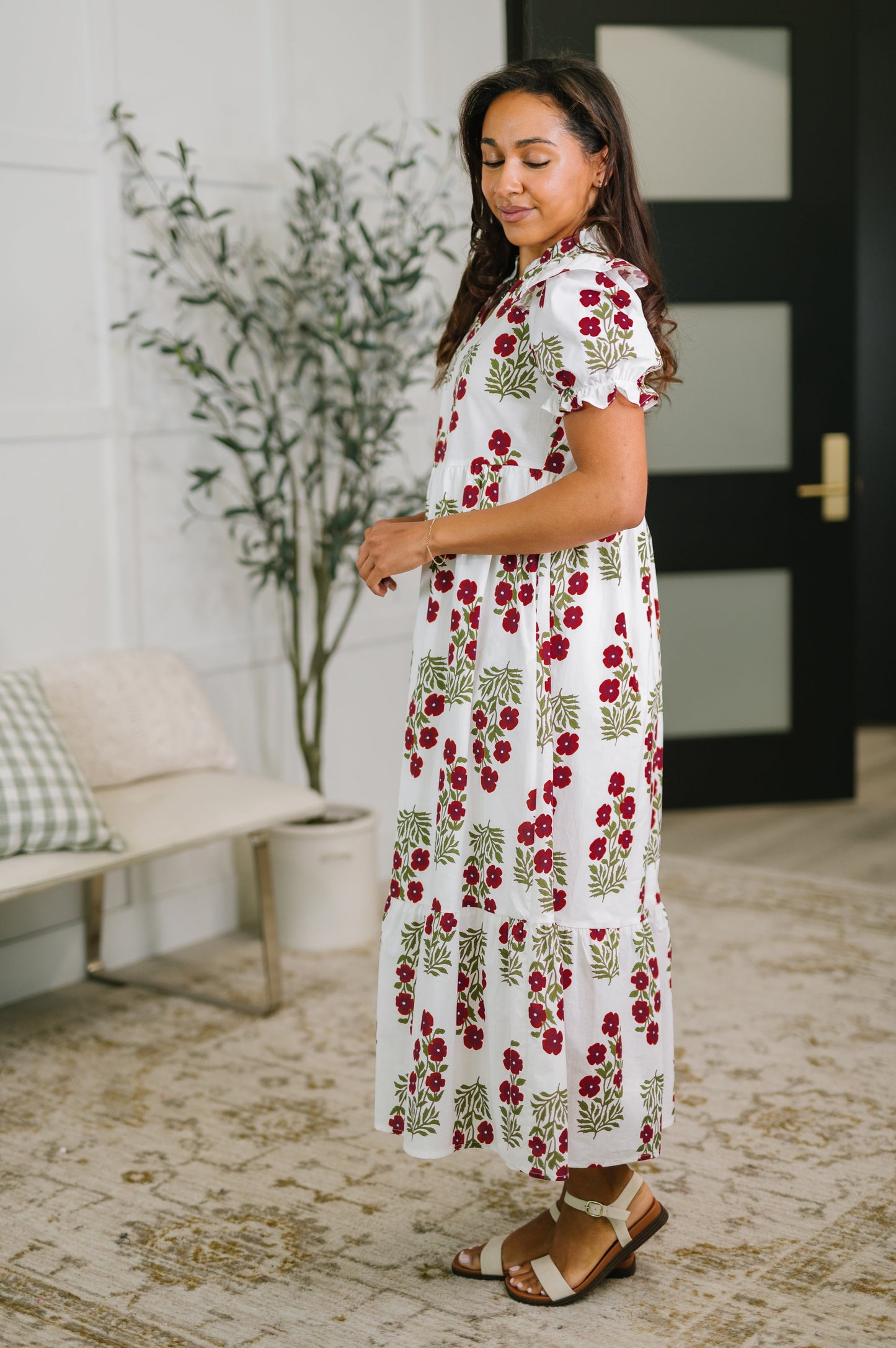 Woman wearing a floral dress in a home setting