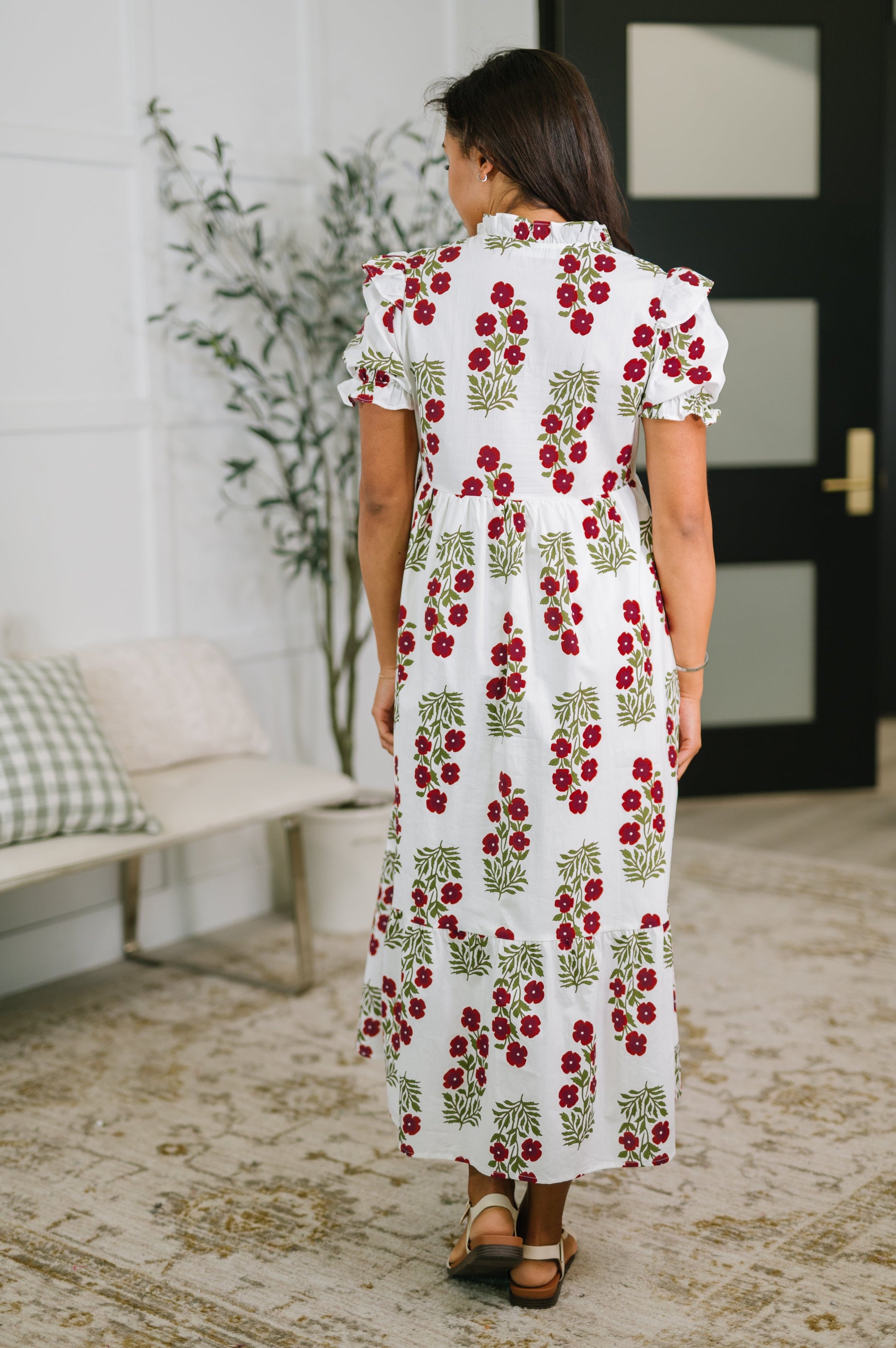 Woman wearing a floral dress in a home setting