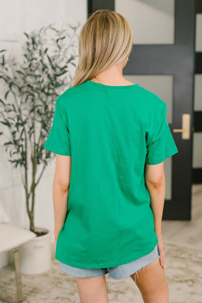 Person wearing a green t-shirt in an indoor setting