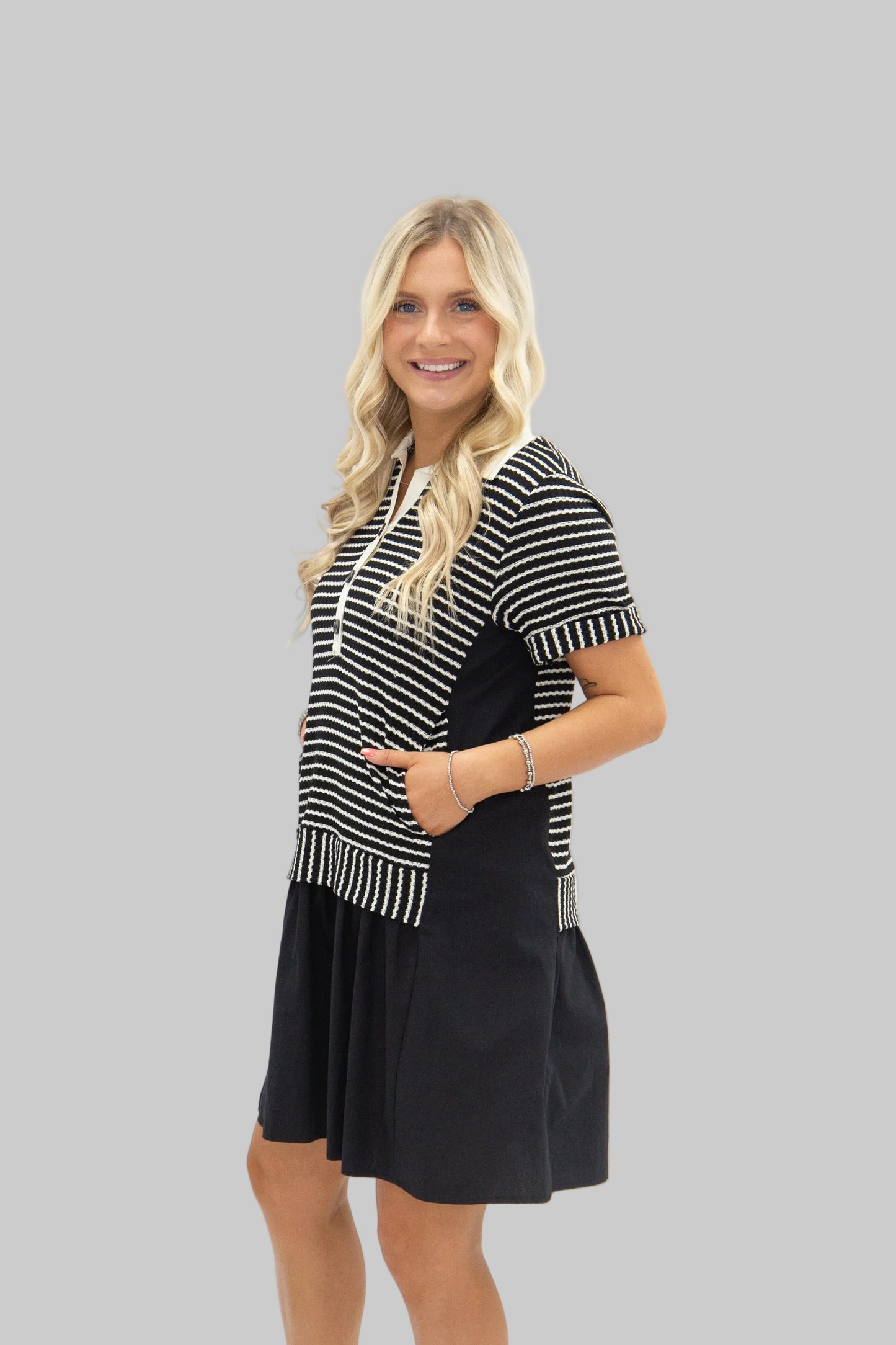 Woman wearing a black and white striped dress on a white background