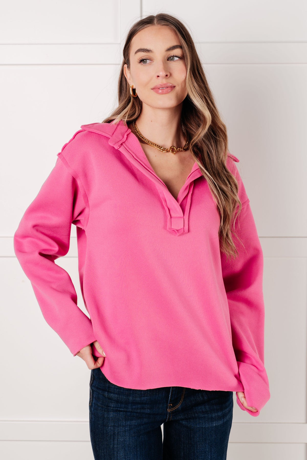 Woman wearing a pink pullover with a white background