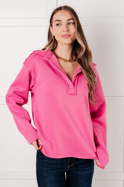 Woman wearing a pink pullover with a white background