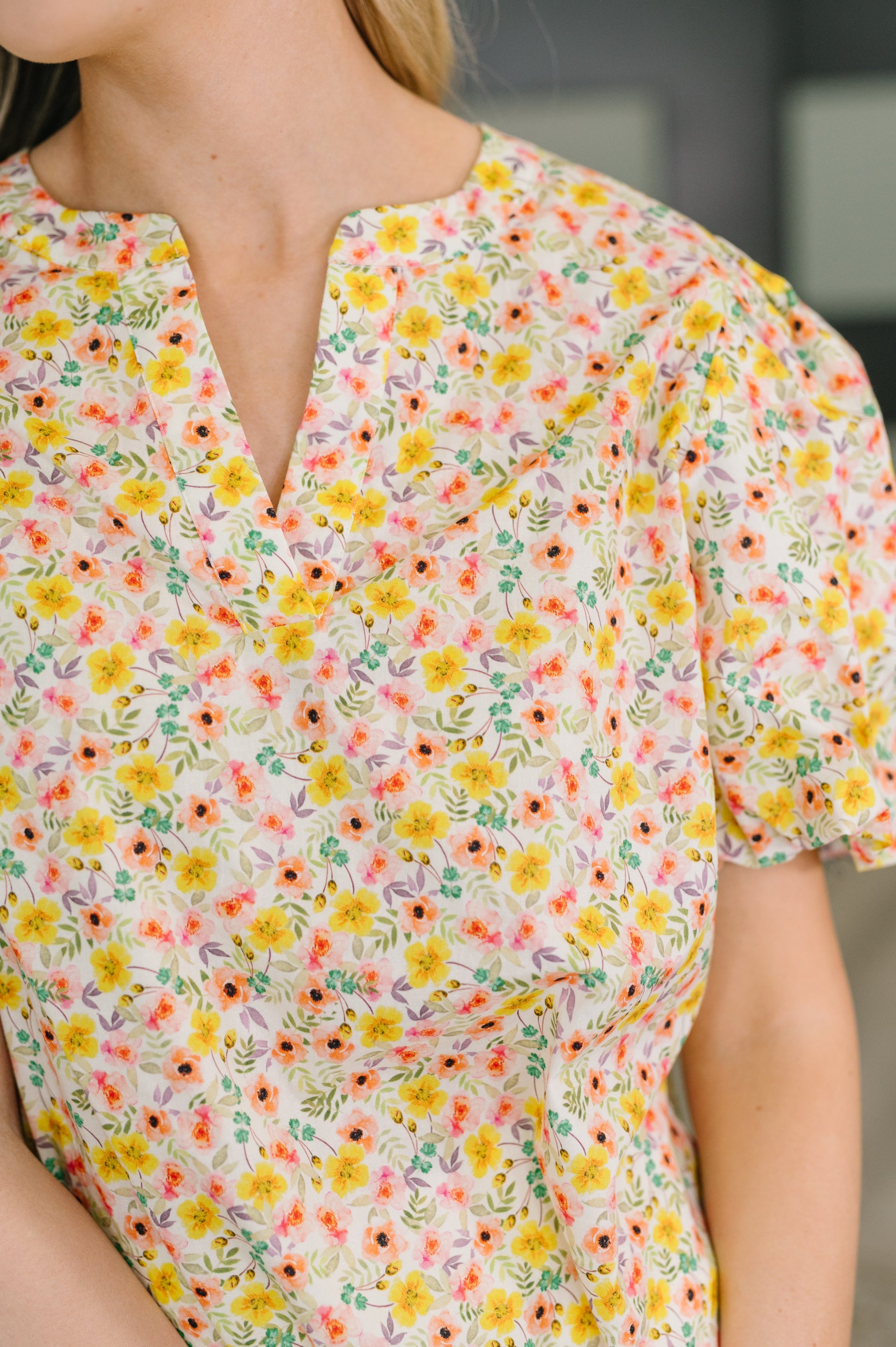 Woman wearing a floral blouse with a blurred background