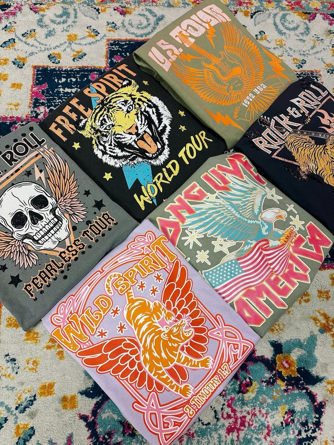 Photo of six different graphic tees 