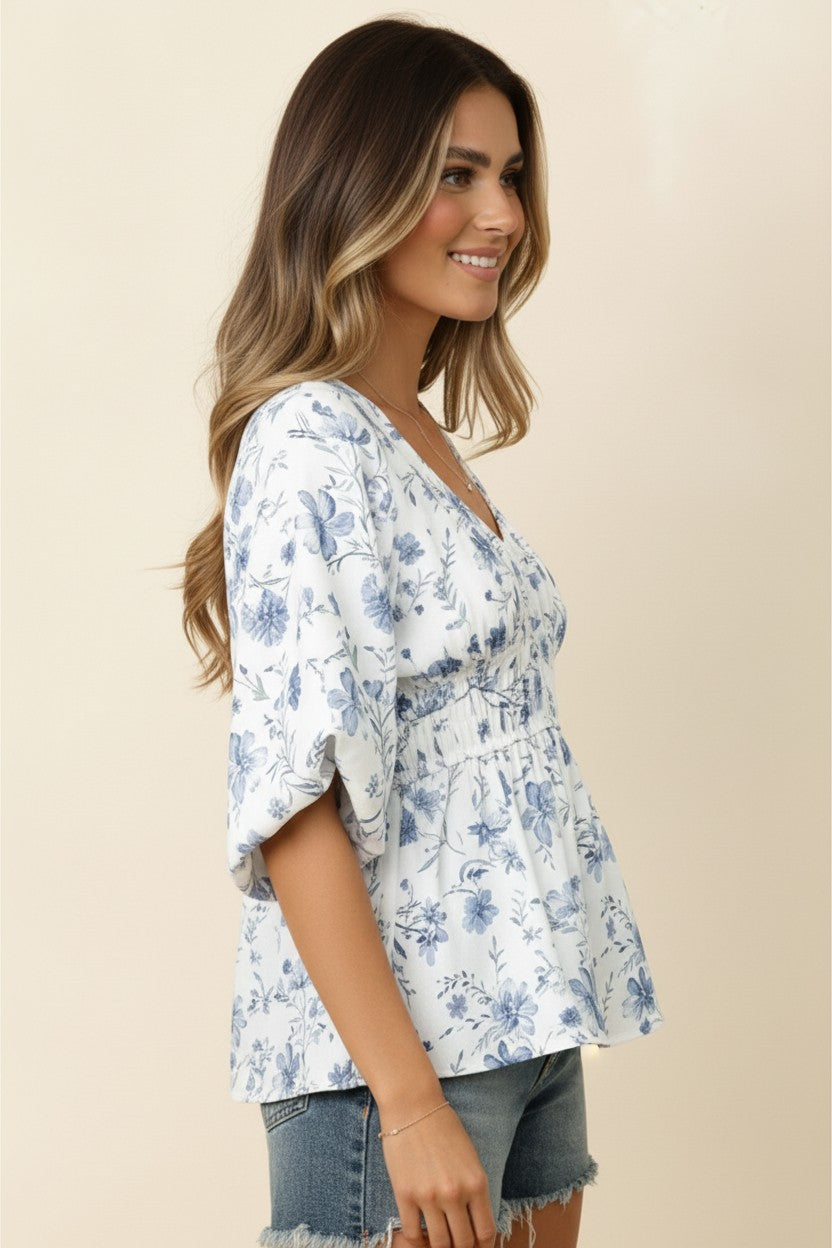 Woman wearing a floral blouse with a beige background