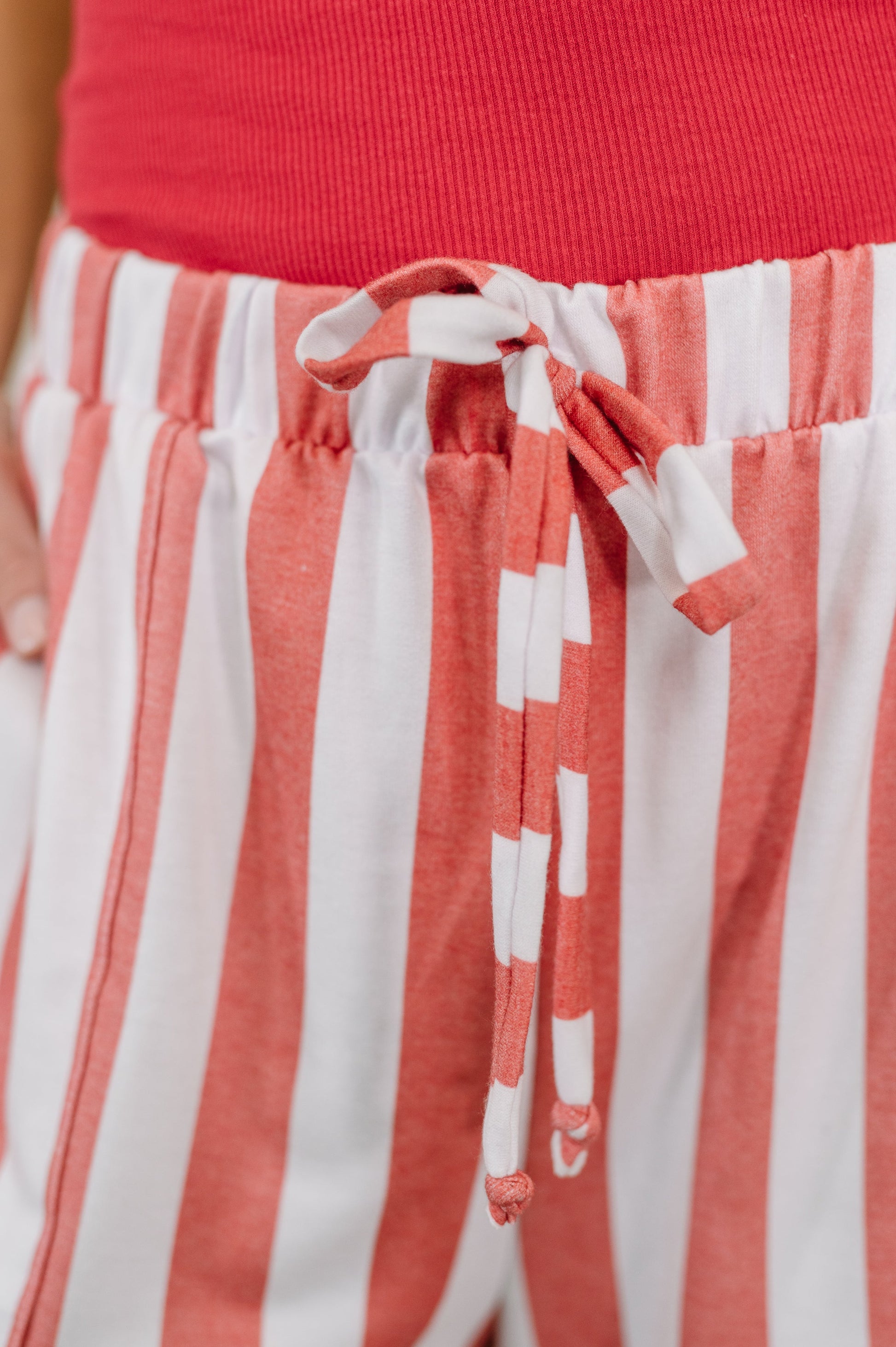 Red top and white and red striped pants with a tie waist.