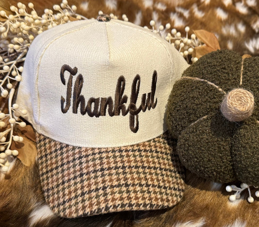 Trucker hat with 'Thankful' text on a decorative background with pumpkins and berries