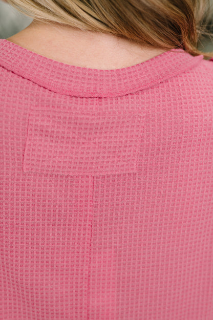 Close-up of a pink textured garment with a blurred background