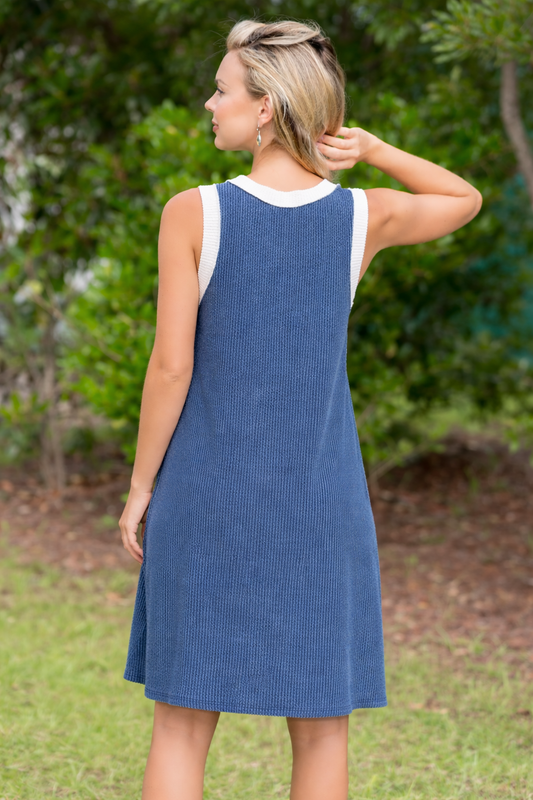 Woman wearing a blue dress with a white top outdoors