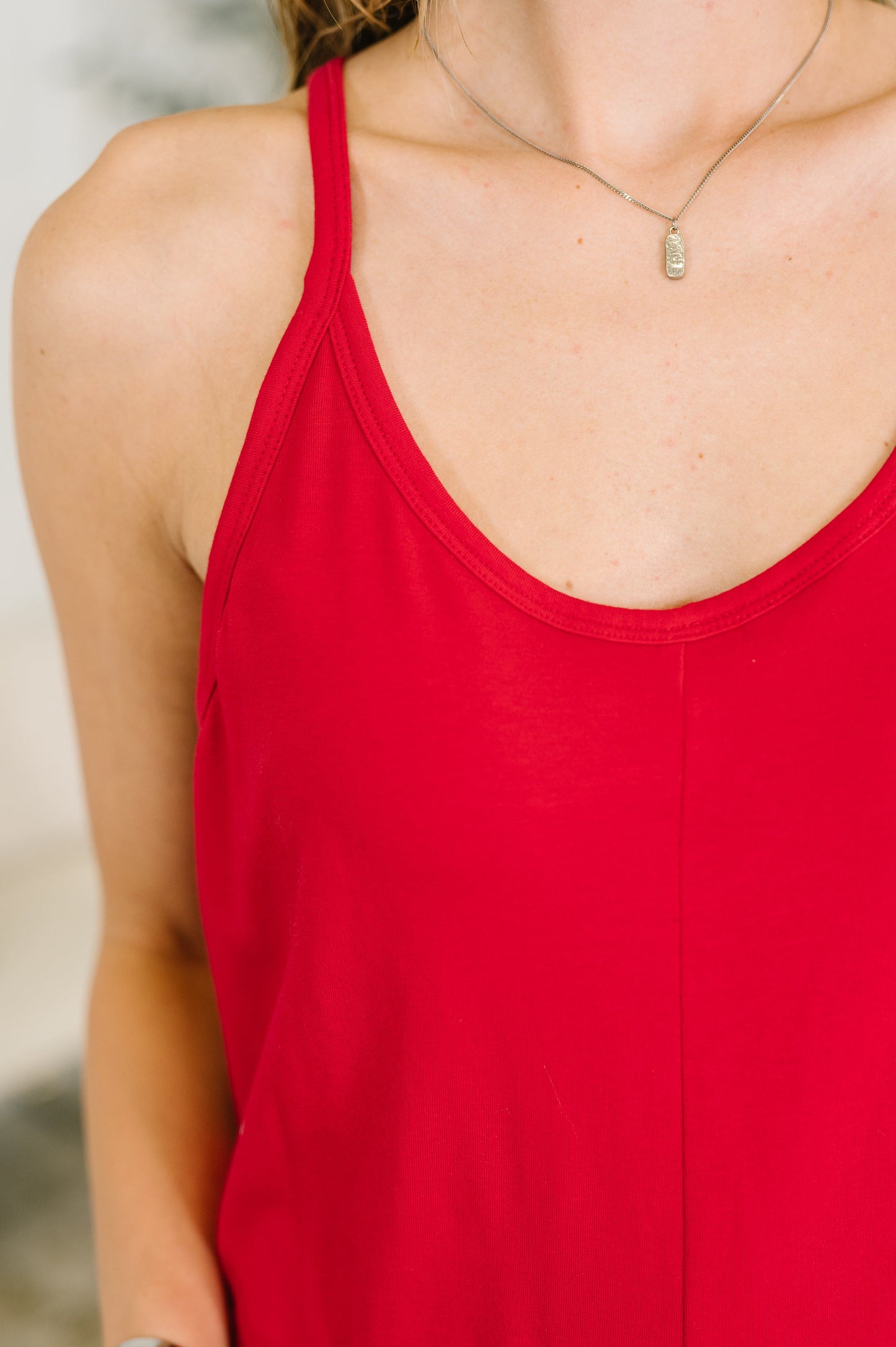 Red tank top worn by a person with a blurred background